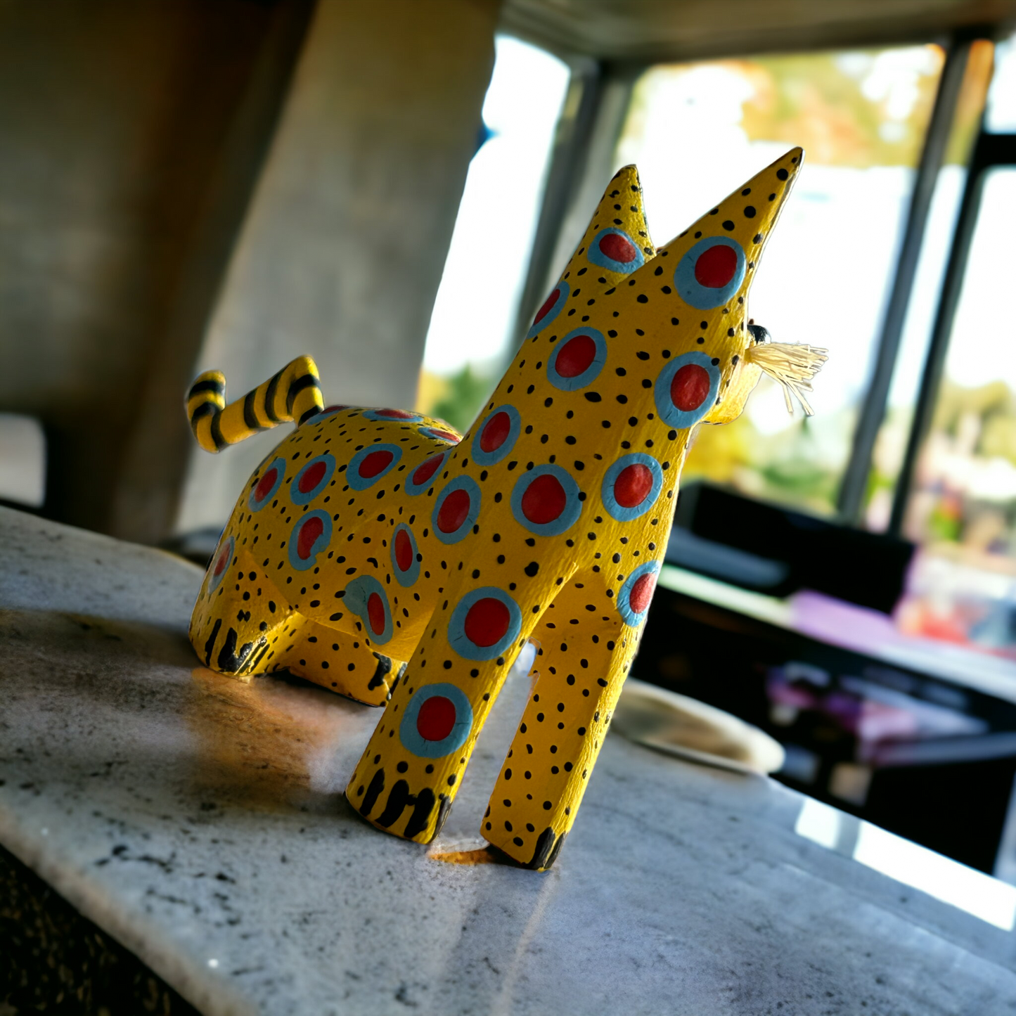 Stunning Alebrije from Oaxaca Mexico, a handcarved copal wood treasure showcasing a yellow cat with blue and red spots