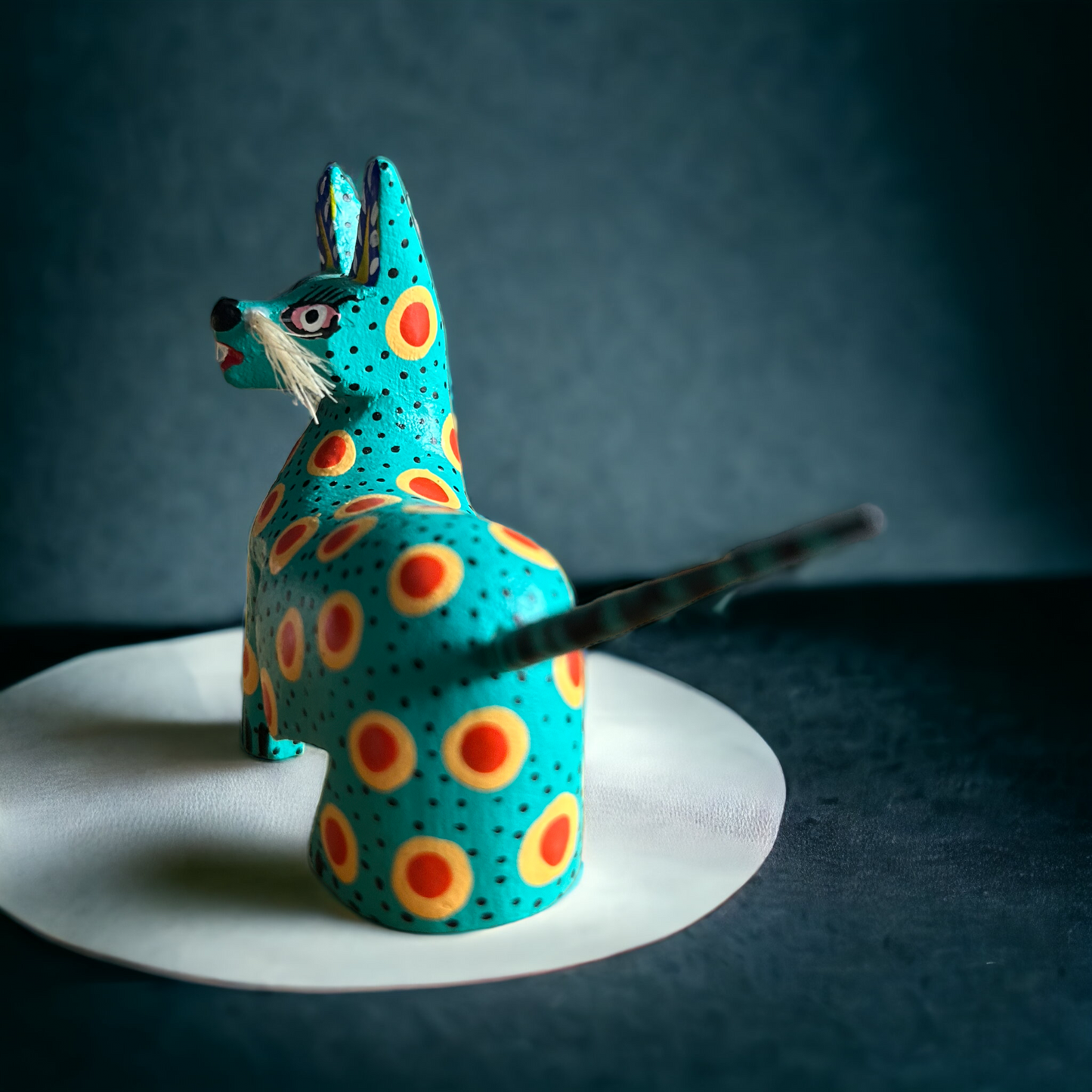 A vibrant feline alebrije in an exquisite hand carved technique , exuding an aura of elegance and charm